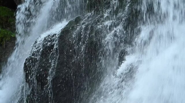 Closeup of a waterfall flowing over mossy stones, slow motion, Josefsthaler Wasserf&auml;lle
