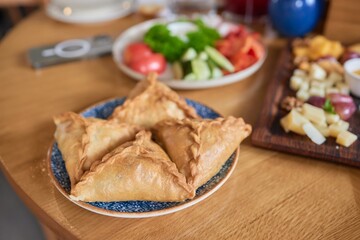 Delicious Golden Samosas Served in a Very Vibrant Setting with Energetic Atmosphere
