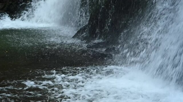 A waterfall flowing over mossy stones into its pond, slow motion, Josefsthaler Wasserf&auml;lle