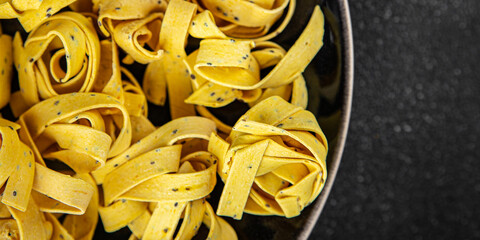 Fresh tagliatelle with chia seeds raw pasta dish gourmet food background On the table rustick food...