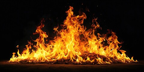Obraz premium Realistic fire flames blazing in the night illuminating the darkness
