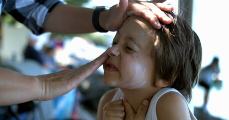 Sunscreen being spread on a child's face in slow motion at 800 fps, highlighting the detailed care and protection given during sunny outdoor activities