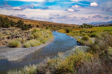 The John day River winds througfh sage brush and agricultural land just west of Dayville Oregon