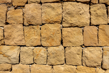 Large sandstone block patterned brick wall closeup
