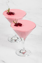 Italian Pomegranate cream jelly dessert, Panna Cotta in martini glass. Light background. Close up