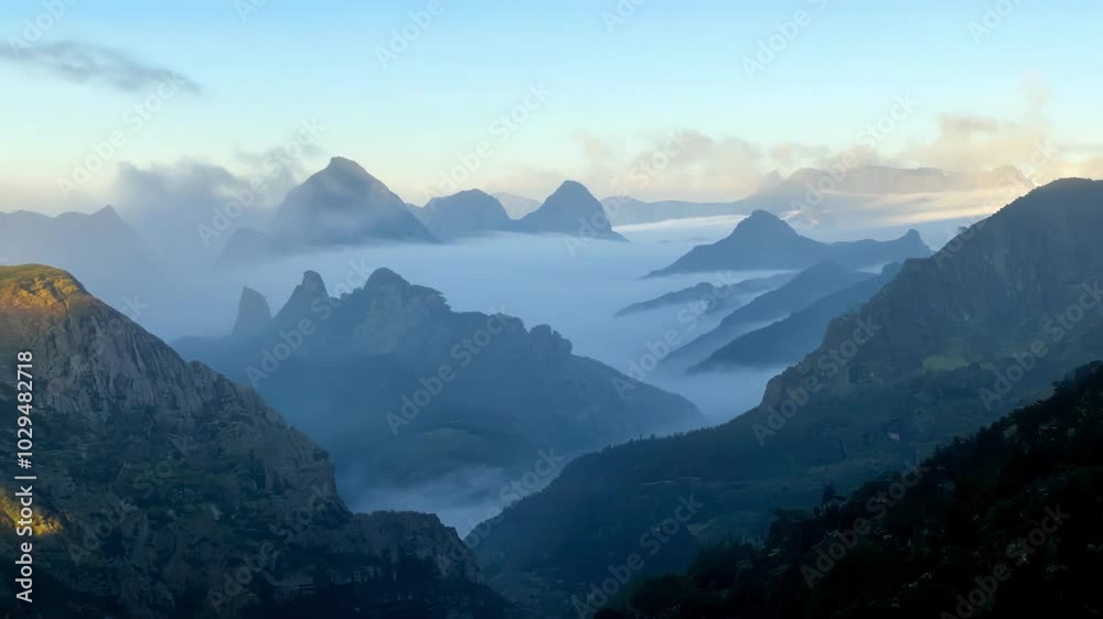 Aufkleber Silhouettes of mountain peaks emerging from a thick fog bank during blue hour, creating a moody and atmospheric landscape