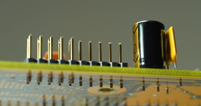 Computer microcircuit with electronic components, resistors and connection terminals. Cinema 4K 60fps zoom-out video