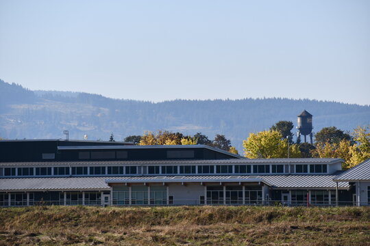 Modern day school building. Lots of big windows and natural light. Water tower in the horizon.