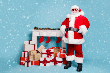 Full length body size view of his he nice cool fat cheerful cheery glad content bearded Santa standing near fire place house gift delivery service isolated on blue turquoise pastel color background