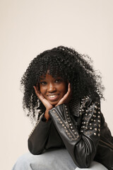 Close-up of smiling dark-skinned woman with afro hairstyle posing indoor. Mindset and mental health.