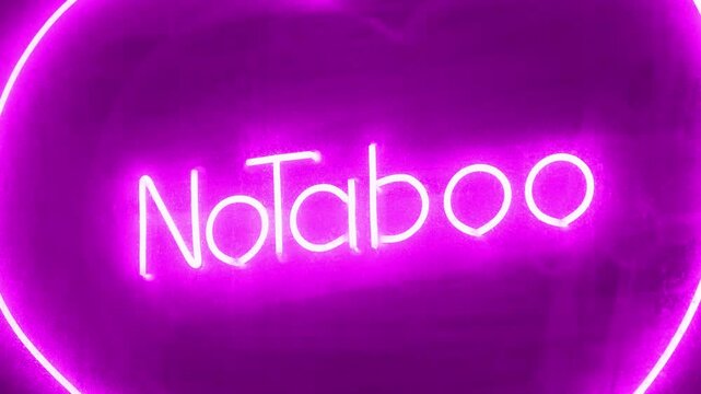 No Taboo inscription in pink color at sex shop window. Peccability and moral degradation of society, decline in morals