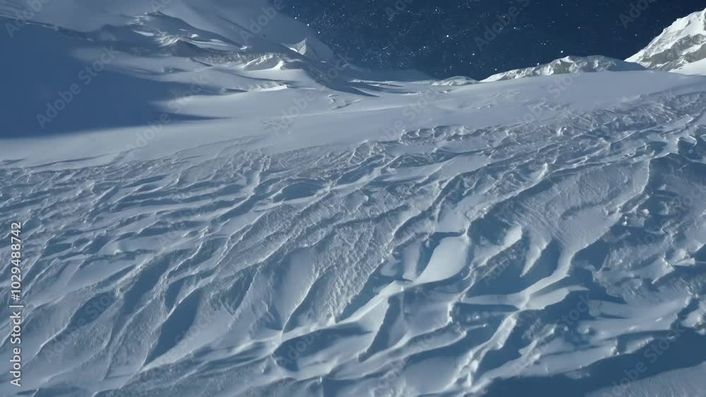 Aufkleber Snow sculpted by strong winds on a remote mountainside, creating intricate patterns and textures