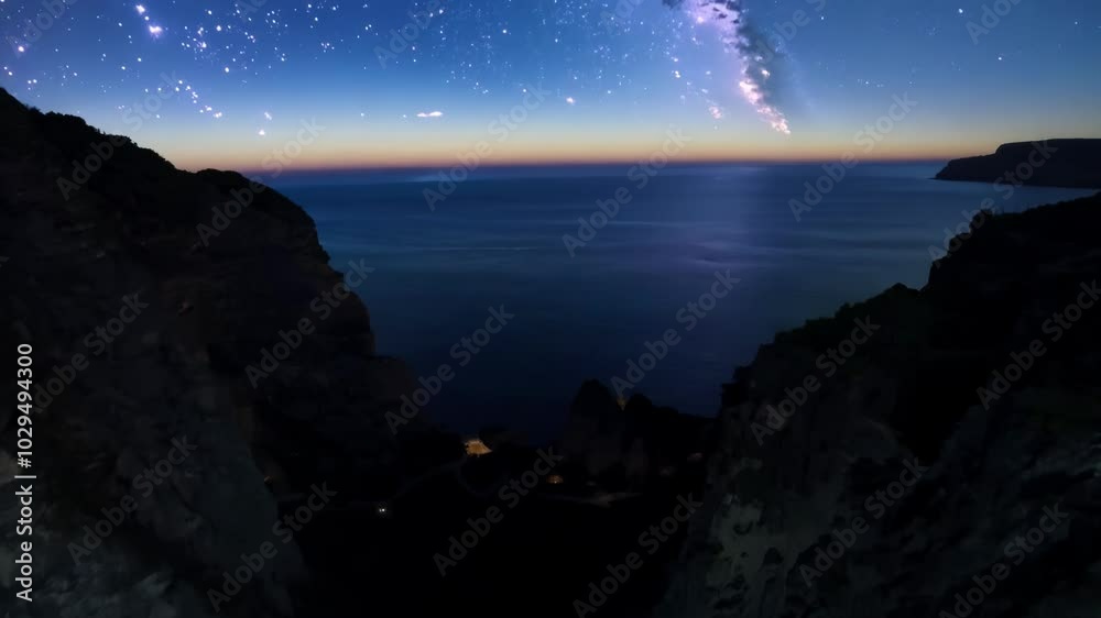Poster dark ocean water crashing between two large cliffs, lit by the setting sun with a faint light illumi