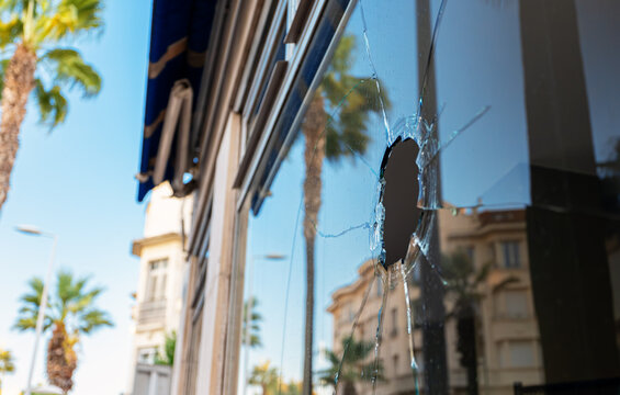 Broken glass in a store on the street. Vandalism and theft concept.
