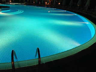 Empty pool with night lighting. Vacation and relaxation concept 