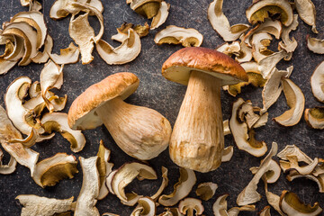 Dried porcini mushrooms. Sliced boletus on black table. Top view.