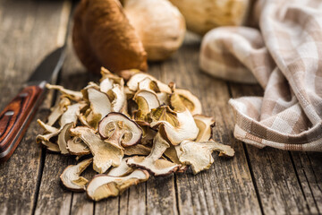 Dried porcini mushrooms. Sliced boletus on wooden table.