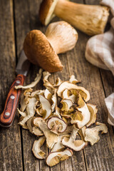 Dried porcini mushrooms. Sliced boletus on wooden table.