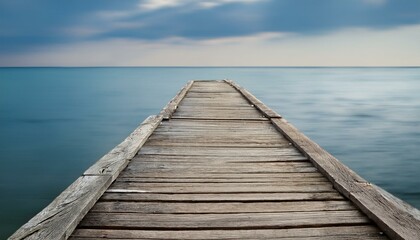 Fototapeta premium An isolated view of the end of a weathered pier, with the soft texture of the aged wood cont