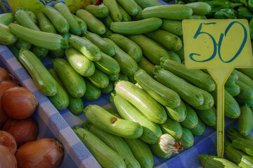 Fresh and Vibrant Cucumbers on Display at the Bustling Farmers Market, Inviting Shoppers to Savor the Local Harvest
