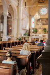 Worshippers attend a religious service in a historic church during a serene Sunday morning