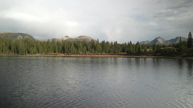 Low aerial over Molas Lake near Silverton Colorado reveal up at sunset