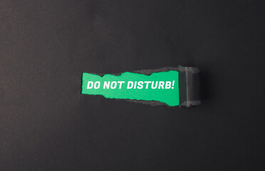 Torn piece of paper with the words Do not disturb written on it