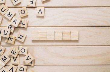 Wooden board with a jumble of letters and a word written in the middle