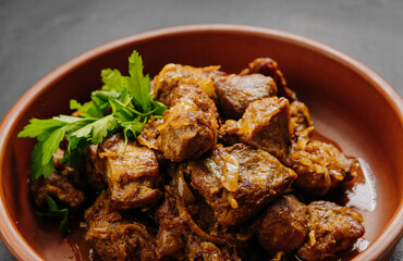 Close up of homemade roasted meat with onions, herbs. Perfect for food blogs, cookbooks, and menus