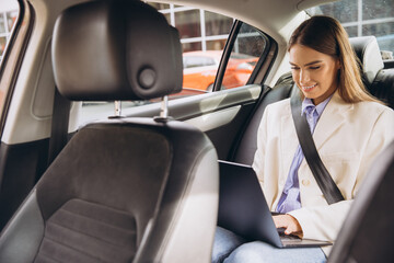 Businesswoman Working Remotely in Car with Laptop on the Go