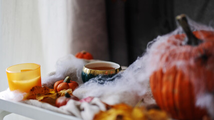 cup of tea with a match in autumn cozy composition for hygge home mood