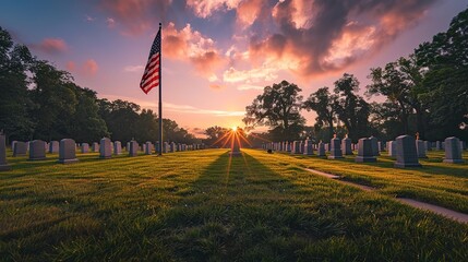A lone American flag stands tall over a cemetery at sunset. .