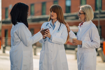 Medical team discussing patient information during coffee break