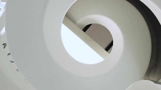 Spiral staircase in The Museum of the Future, bottom view. Modern interior design. Futuristic abstract architecture in Dubai city, United Arab Emirates. View from below