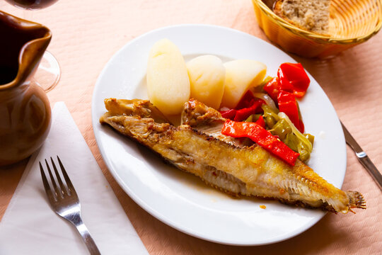 Roasted ballan wrasse (maragota) served with marinated vegetables and potato - Spanish fish dish