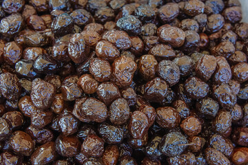 Delicious Dried Dates Piled High, Showcasing a Rich Variety of Textures and Hues, Perfect for Snacking or Culinary Delights