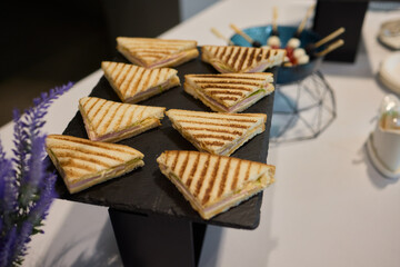 Indulge in Delicious Grilled Sandwiches Served on an Elegant Black Tray for Everyone