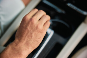 Close up of a man s hand adjusting the control in a car s interior