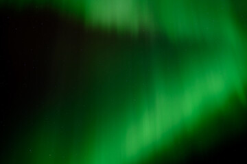 A dark night sky filled with bright green Aurora creating patterns, Sky only

