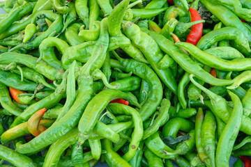 A pile of green chili peppers at a local market
