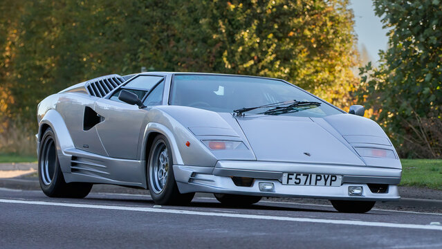 Classic 1988 silver Lamborghini Countach driving on an English country road