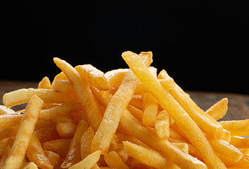 Portion of french fries served on plate on white background. Selective focus