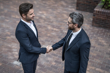 Successful agreement in business deal. Businessmen dealing outdoor. Partnership concept....
