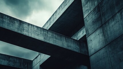 Low angle view of a modern concrete building with an overcast sky in the background.