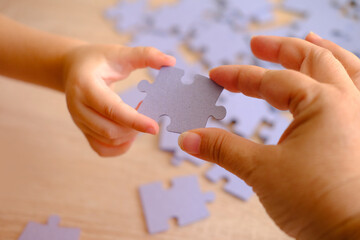 little child and mom playing together, parent teaches daughter to assemble puzzles, cognitive development through puzzle-solving, Parental Involvement in Learning