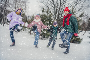 Photo of positive cheerful little child wife husband dressed coats walking having fun enjoy good weather together outdoors urban forest park