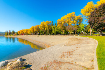 Autumn view of the city park and city beach alongside waterfront homes on Lake Coeur d'Alene, in...