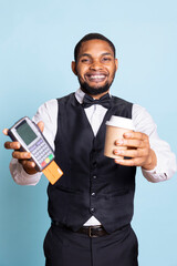 African american bellhop pointing at the pos terminal and asking for the payment, service oriented hospitality industry. Symbolizing electronic transaction for the lodging.