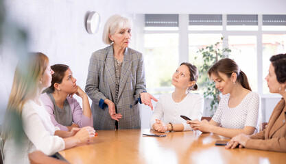 during morning five minutes, colleagues sit at table and animatedly discuss set of tasks for day....