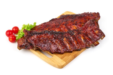 Grilled pork ribs with barbecue sauce, lettuce, and cherry tomatoes, isolated on white background.